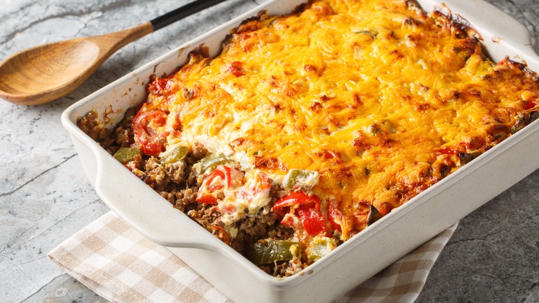 Cheesy beef and pepper "John Wayne" casserole in white baking dish