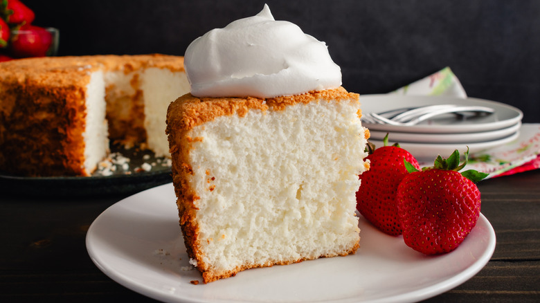 slice of angel food cake topped with cream with berries