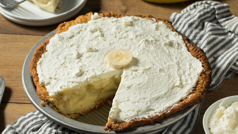 Banana cream pie in silver dish on table