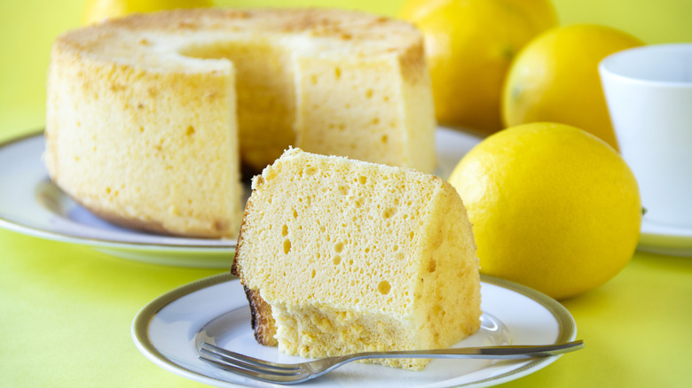 lemon chiffon cake on plate with lemons