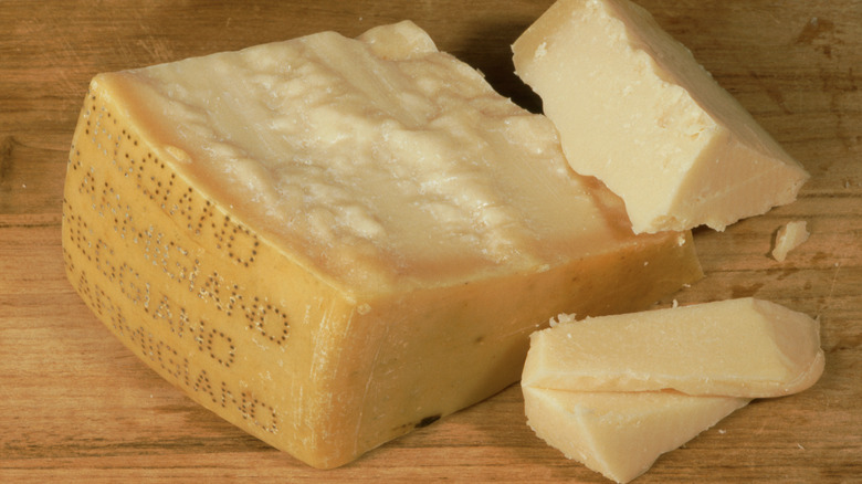 Block of parmesan cheese on wooden table