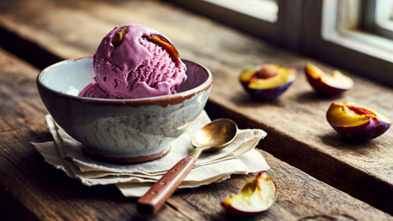 Bowl of plum ice cream on wooden table