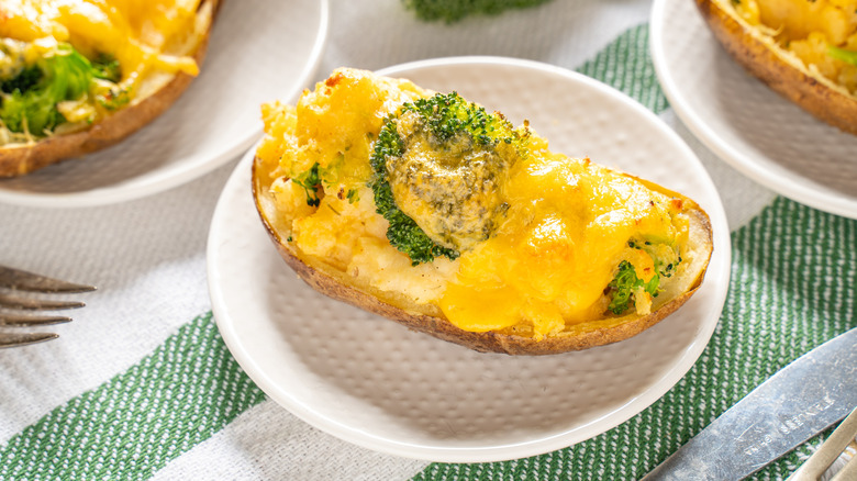 A baked potato topped with cheddar and broccoli