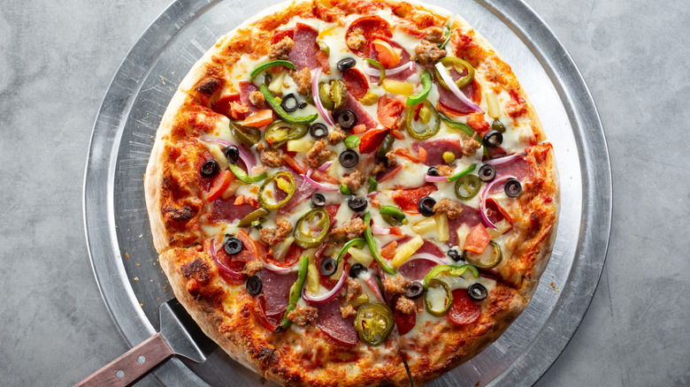 A pizza topped with sausage and veggies