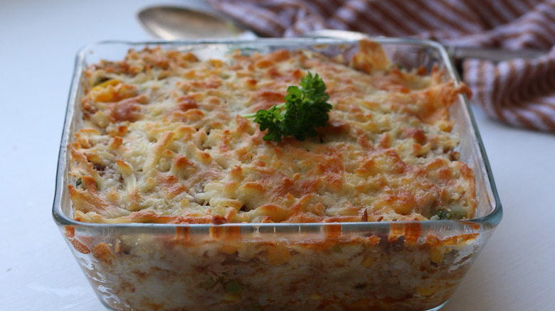 A cheesy rice tuna casserole baked in a glass dish