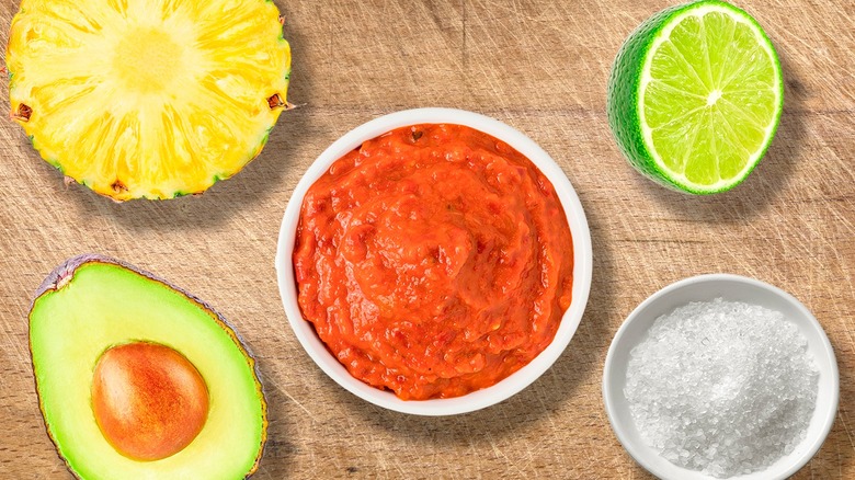 sliced fruits and vegetables and bowl of salsa