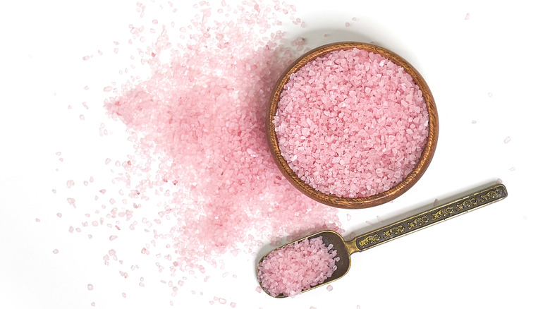 Pink granulated decorative sugar on a white background.