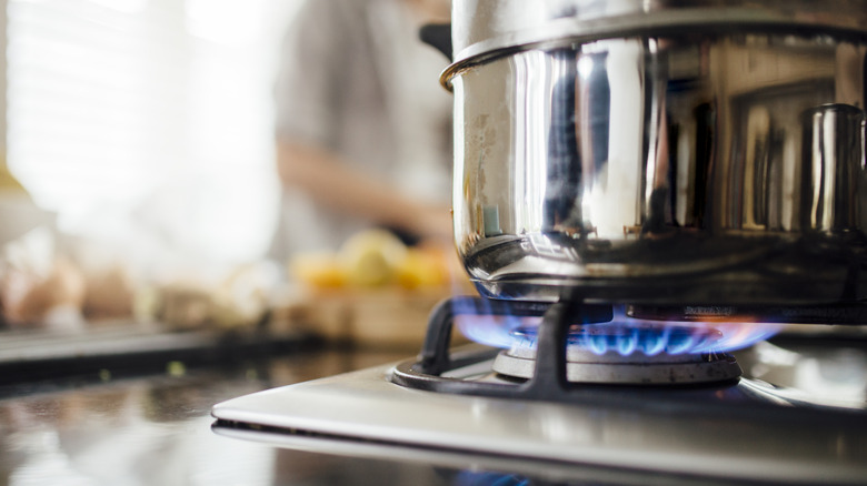 a stainless steel pot sitting on a gas stove
