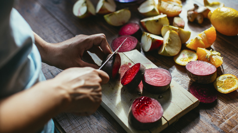 Woman dicing purple beets
