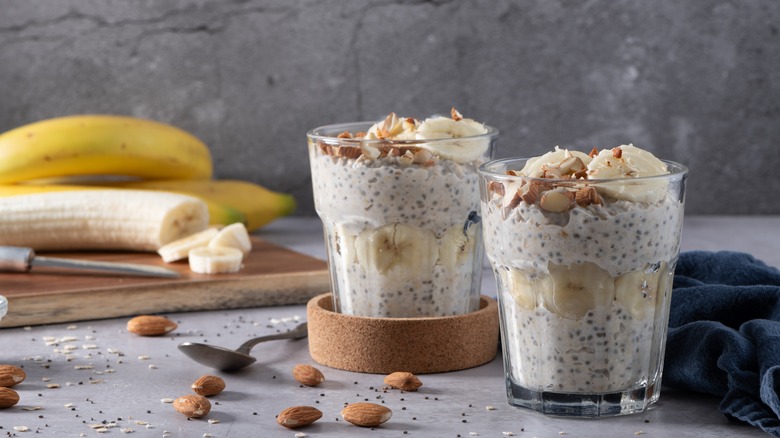 Overnight oats topped with bananas in glasses