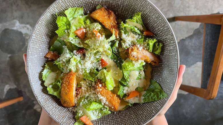 Bowl of Caesar salad with crispy chicken pieces
