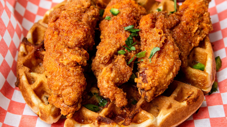 Crispy chicken and waffles with parsley garnish