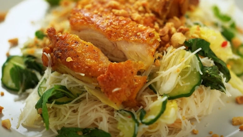 Crispy sliced chicken laid on top of noodle salad