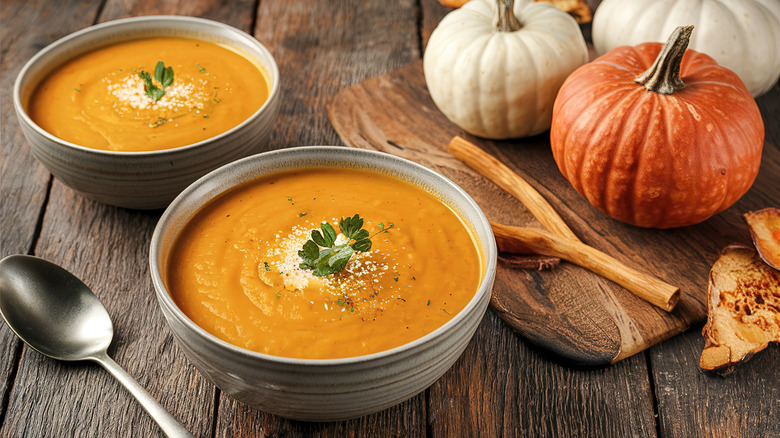 Two bowls of pumpkin bisque with pumpkin spice