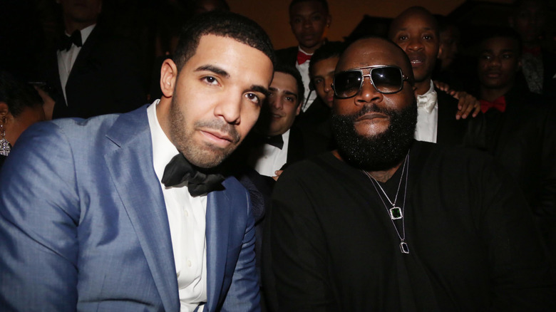 Drake and Rick Ross posing for a photo at a party
