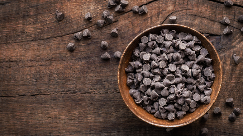 dark chocolate morsels in a wooden bowl