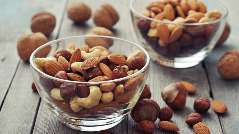 assorted nuts in a two glass bowls