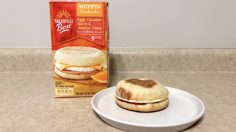 Aldi Canadian bacon, egg, and cheese muffin breakfast sandwiches in box and on plate.