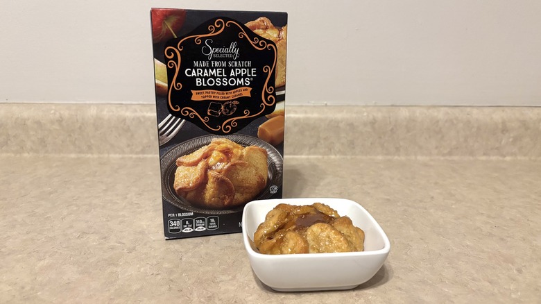 Caramel apple blossoms in a bowl and box on neutral background.