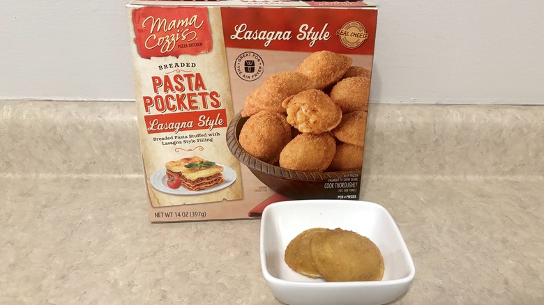 Lasagna style breaded pasta pockets in bowl and box on neutral background.
