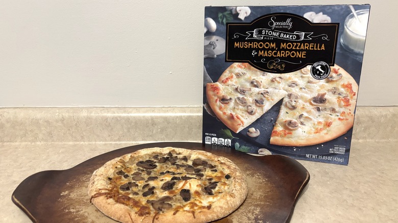 Mucshroom, mozzarella, and mascarpone box and on a pizza stone.