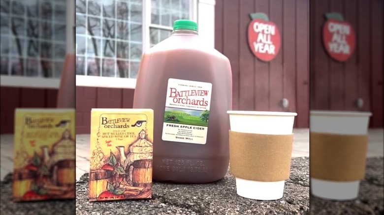 A flagon and paper cup of hot apple cider at Battleview Orchards