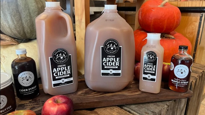 Bottles of apple cider, cider syrup, and maple syrup on display at Champlain Orchards