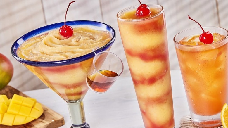 A blended orange and red drink in a tall glass, topped with an orange wedge and a cherry. The Red Lobster logo appears in the top right corner, with the caption "Bahama Mama for the soul" below.