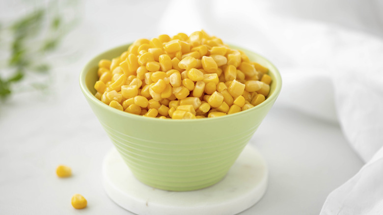Canned sweetcorn in a pale green bowl