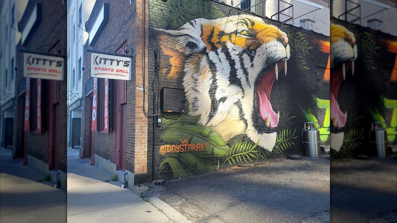 The outside wall of Kitty's Sports Grill, featuring a large paainted tiger's head growling