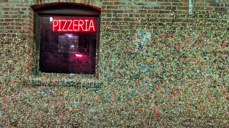 Neon pizzeria sign on the Seattle Gum Wall in Post Alley