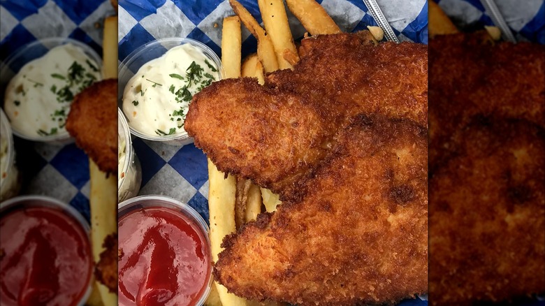 Fish and chips with condiments on blue and white checkered paper from Seattle Fish Company