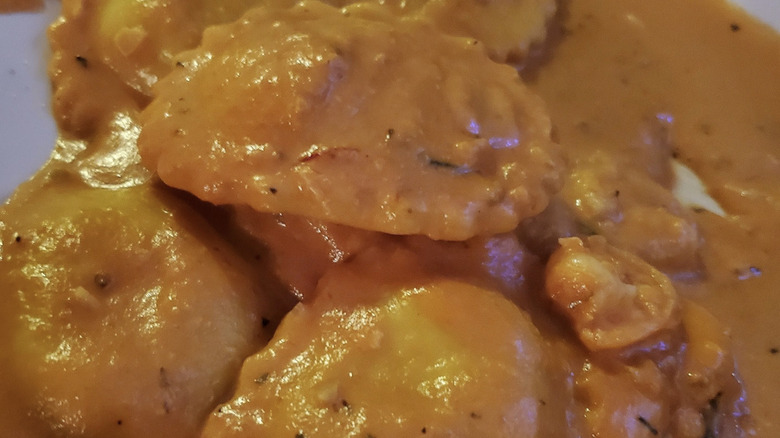 Seafood ravioli with orange pasta sauce from Zouave Seattle