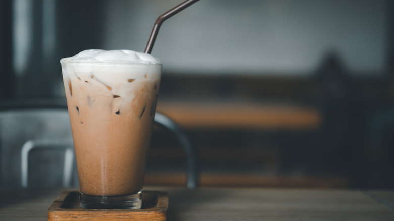 Cup of iced coffee with cold foam on top