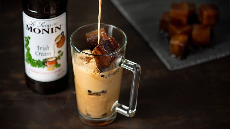 Monin Irish Cream Syrup being poured into iced coffee