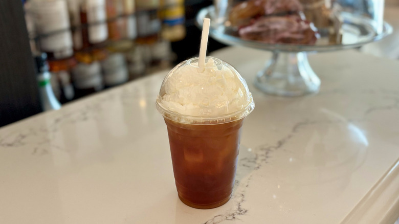 To-go cup of coffee with whipped cream on top