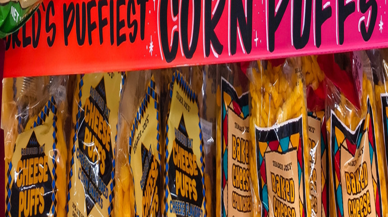 Bags of Trader Joe's Sour Cream and Onion Corn Puffs on store shelf