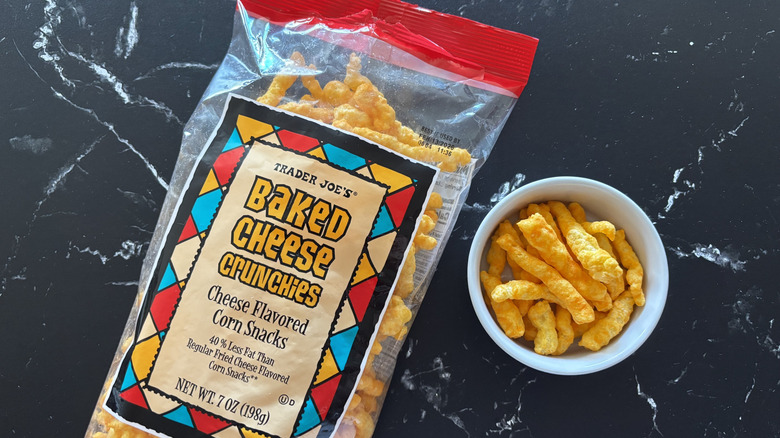 Trader Joe's baked cheese crunchies bag next to small bowl with cheese crunchies