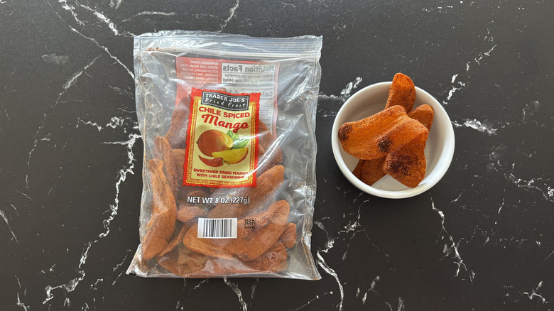 Trader Joe's chile spiced mango bag next to chile spiced mango pieces in bowl