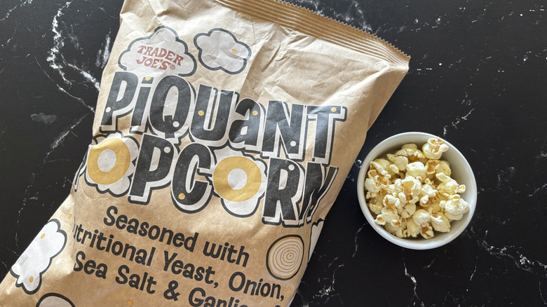 Trader Joe's piquant popcorn bag next to small bowl of popcorn
