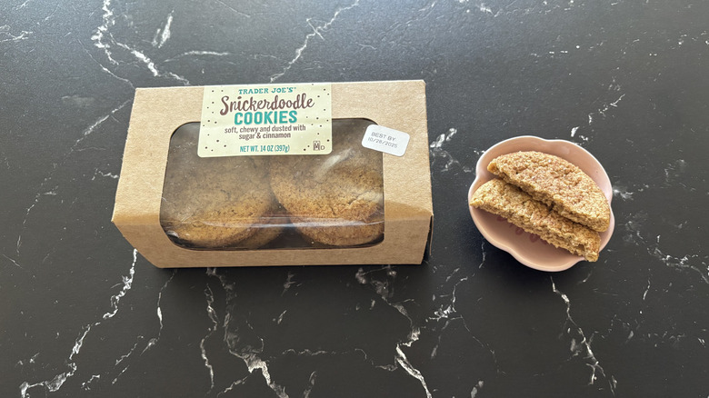 Trader Joe's snickerdoodle cookies container next to halved cookie on plate