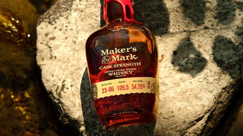 A top down shot of a bottle of Maker's Mark Cask Strength laid on a large stone