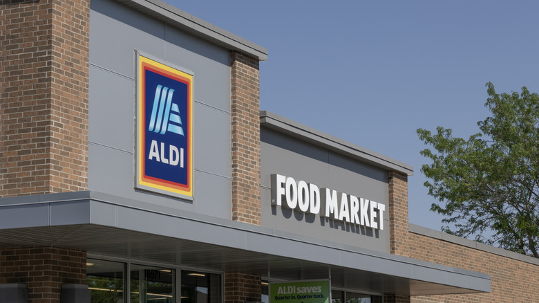 Signs above a brick Aldi store during the day