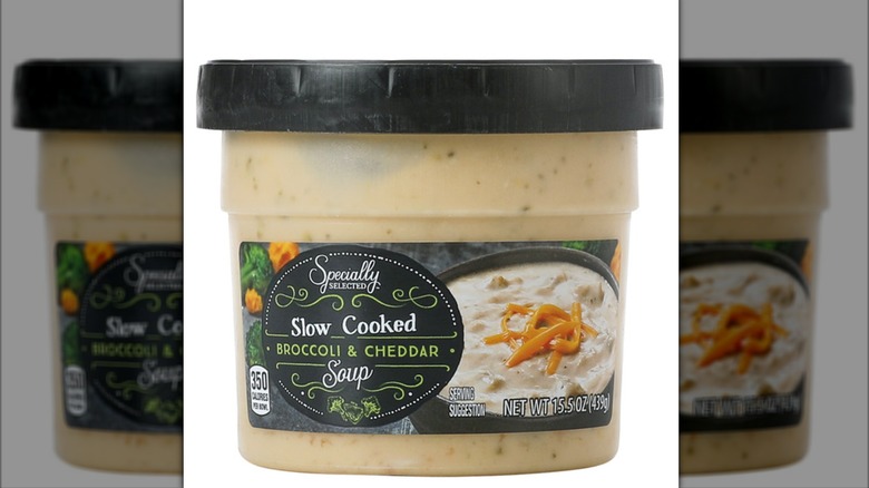 A container of Specially Selected Slow-Cooked Broccoli and Cheddar Soup isolated on a white background