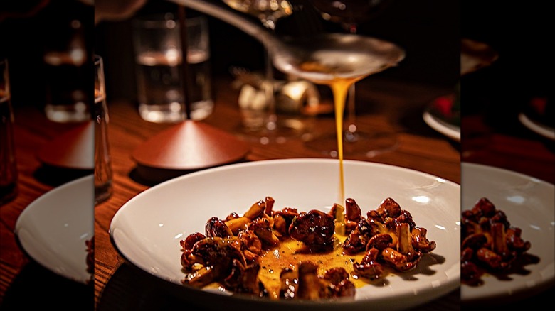 Mushroom and egg dish being finished at the table