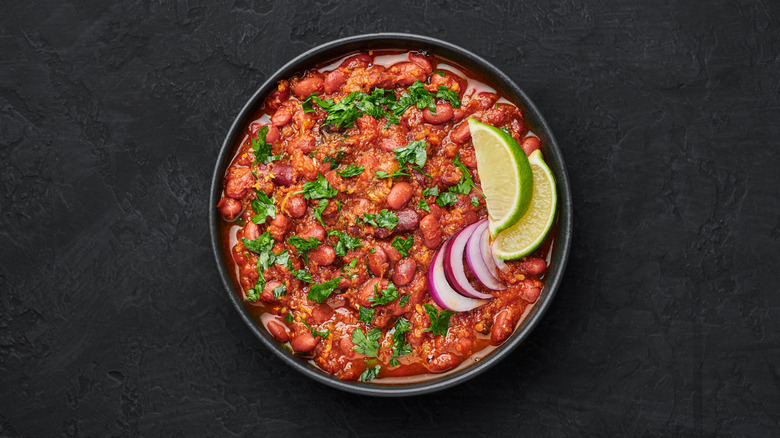 Rajma masala in a black bowl set against a dark background.