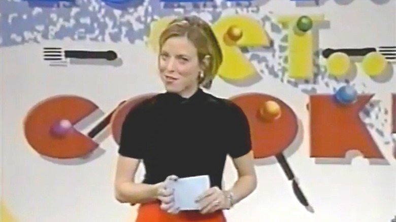 Host of "Ready... Set... Cook!" in front of set logo