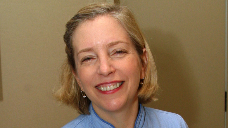 Smiling Sara Moulton in front of wall