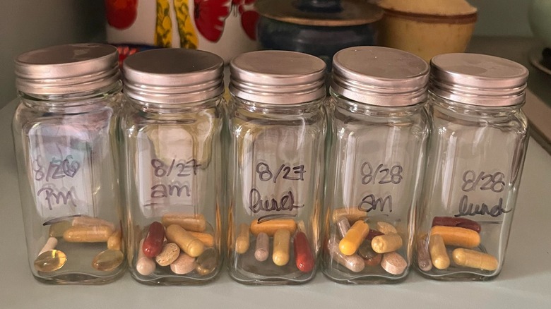 Spice jars labeled with the date and am/pm hold pills.