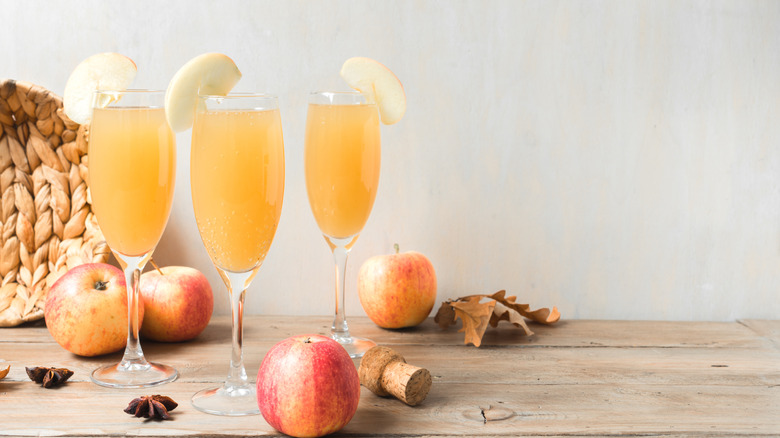 Three apple mimosas with apple garnishes